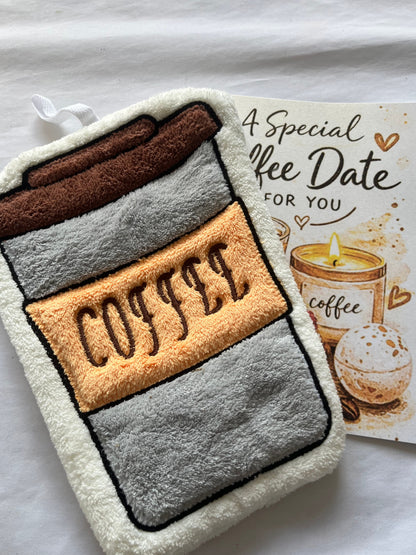 Towel face with 'COFFEE' text on a white surface