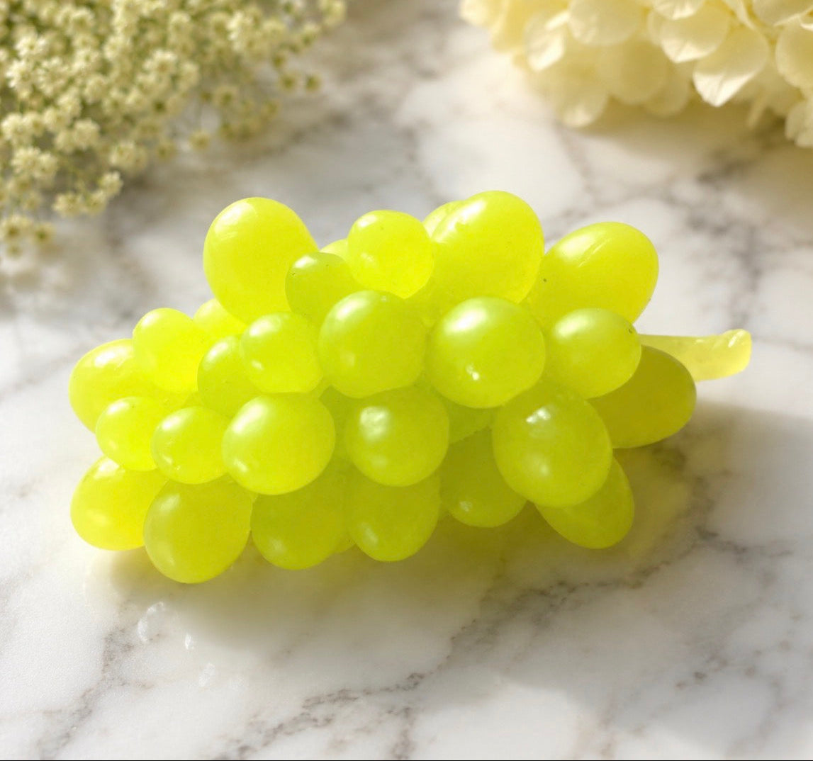 Bunch of green grapes soap on a marble surface